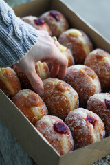  person reaching for donut 