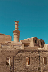 ruins of an ancient Persian castle with adobe houses and a shaking tower in details. 