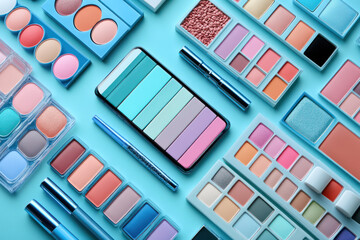 Colorful makeup products arranged in creative flat lay on blue background, featuring various palettes and tools for beauty enthusiasts..
