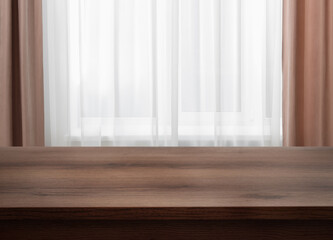 Fototapeta premium Empty wooden table near window with curtains. Space for design