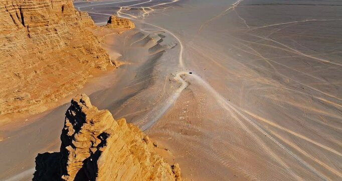 Aerial view of the road and spectacular Danxia landform natural scenery. The famous Dahaidao uninhabited area natural landscape in Xinjiang, China.