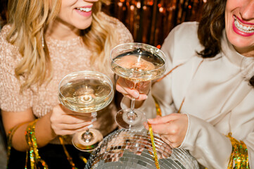 Smiling women toasting with champagne during festive celebration