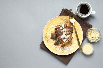 Cake roll in a bowl with coffee on a light background