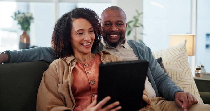 Mature couple, tablet and relax on sofa with smile, reading and choice for movie, streaming or funny meme. People, man and woman with interracial love, touchscreen and app for social network in home