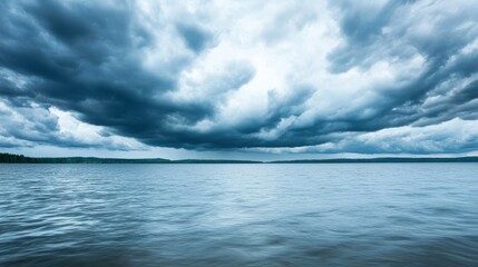 Obraz premium Dramatic sky over tranquil water, showcasing dark clouds reflecting on the surface, creating an atmosphere of serenity and mystery.