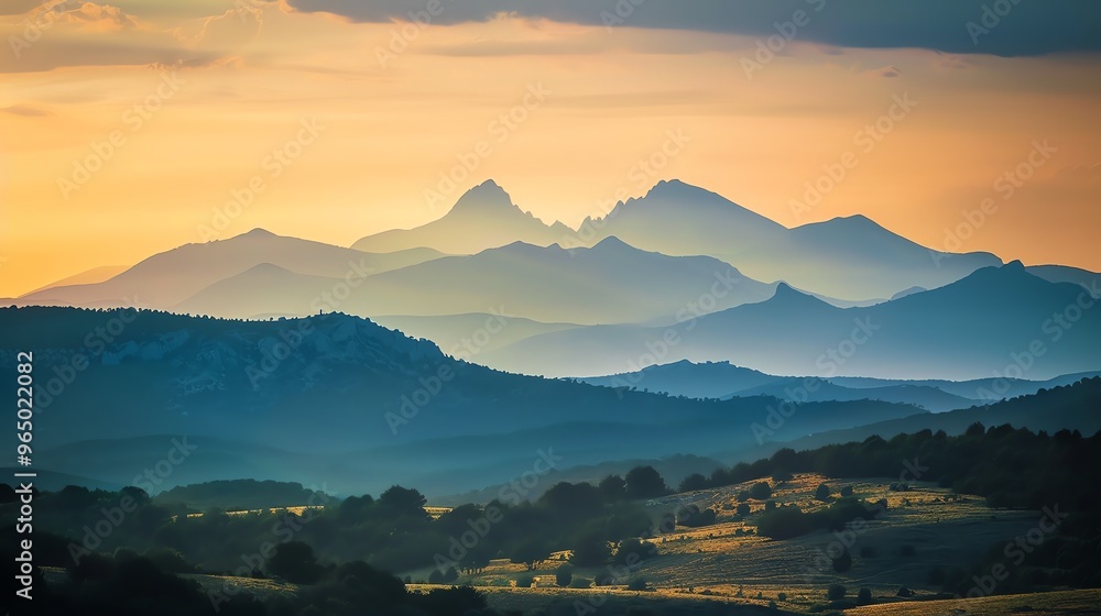 Wall mural a stunning sunset view over rolling hills and distant mountains.