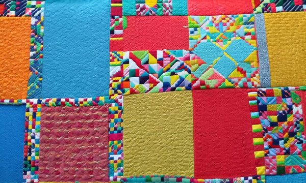 A colorful patchwork quilt, its squares of fabric sewn together with love and care. Video
