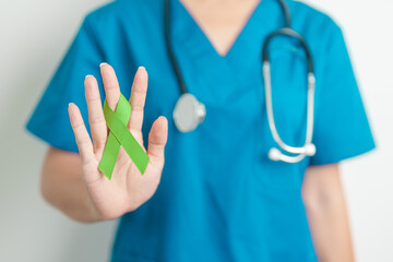 Doctor with green Ribbon for world Lymphoma Awareness September month, world Mental Health Day,...