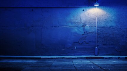 Urban Night Scene with Blue Wall and Street Light, Empty Street Photograph