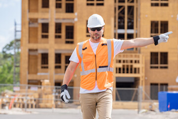 roofer builder working on roog structure of building on construction site. handsome young male...