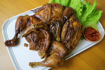 whole roasted chicken or Ingkung ayam and fresh vegetables with chilli sauce.
