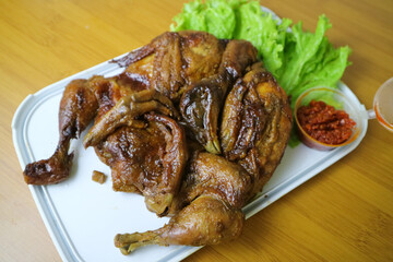 whole roasted chicken or Ingkung ayam and fresh vegetables with chilli sauce.
