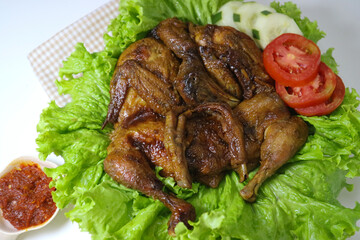 whole roasted chicken or Ingkung ayam and fresh vegetables with chilli sauce.