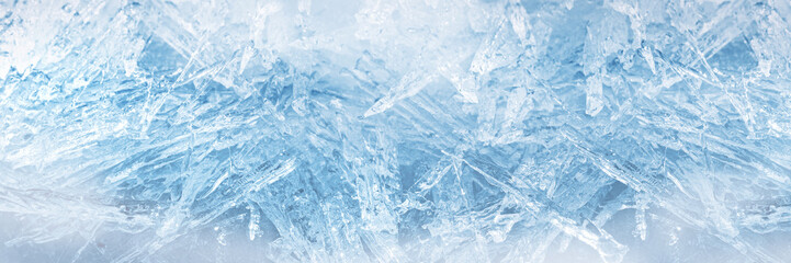 Winter snowy banner, frozen background. A scattering of large long ice crystals in the form of needles on the river in winter. Dark and Light