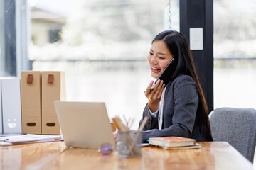 Modern Asian business woman in workplace office, doing planning analyzing the financial report, business plan investment, finance analysis concept