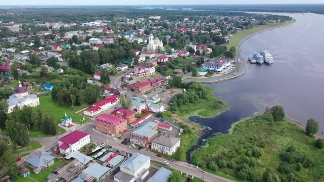 Scenic summer view from drone of ancient town of Myshkin located on steep left bank of Volga overlooking modern river station and medieval temples, Russia