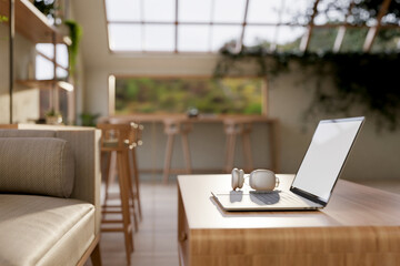 A laptop and headphones on a modern hardwood coffee table in a contemporary coffee shop seating area