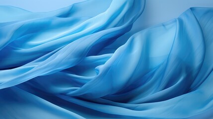 Fototapeta premium A soft, flowing blue fabric drapes gracefully, creating a beautiful abstract pattern.