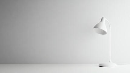 A white desk lamp on a white desk in front of a white wall.