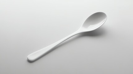 A white ceramic spoon on a white background.