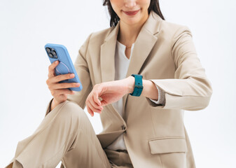 Woman using a smartphone and a smartwatch