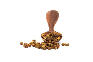 Wooden spoon filled with bee bread granules on white background for natural health concepts