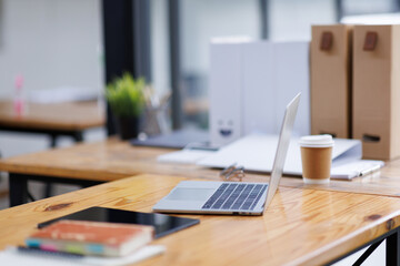 Shot of light cozy laptop computer office interior in modern minimalist style with working desks and plants, copy space