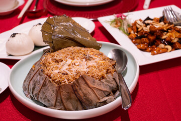 Chinese Seafood Fried Rice Wrapped in Lotus Leaves on the table
