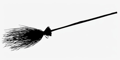 Dark silhouette of a broomstick on a white background evokes a sense of mystery and magic during the Halloween season