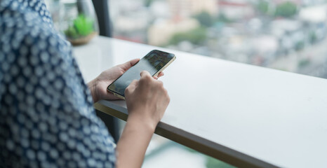 Asian woman using smartphone mobile addict spending time checking news social media cell telephone technology e-commerce concept