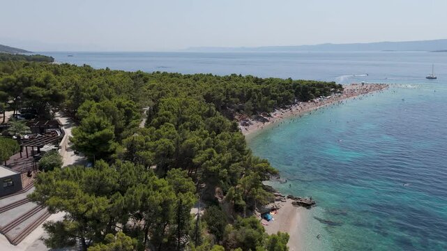 Aerial View of the Paklina Fkk⁩⁦ Beach in Bol on Brac Island, Split Dalmatia, in Croatia. Summer Vacation Resort Near Golden Cape or Golden Horn Zlatni Rat Beach. Famous Adriatic Beach on Adriatic Sea