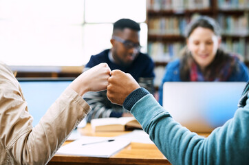 Hands, students and fist bump in library for education, motivation and celebration with group at...