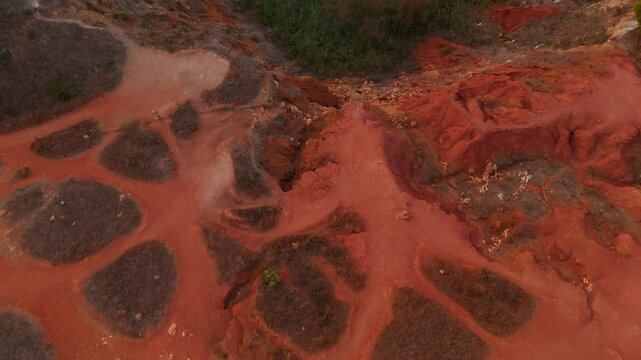 Otranto, Puglia, Italy - The Vivid Red and Orange Hues and the Scenic Beauty of the Bauxite Cave - Drone Flying Forward
