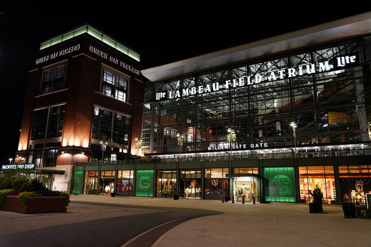 Green Bay Packers Stadium and Titletown Center buildings glow at night.