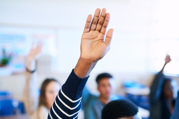 Students, raised hand and classroom at college for question, learning and development with scholarship. People, education and together with sign for feedback, ideas and discussion at university