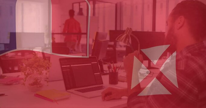 Animation of flag of wallis and futuna over caucasian businessman using laptop