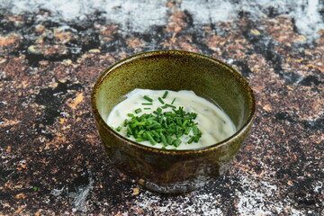Delicious yogurt dip in bowl with chives