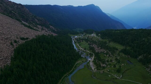 Predarossa Valley And Duino River With Foggy Mountains In Background. Val Masino, Sondrio, Italy. aerial shot