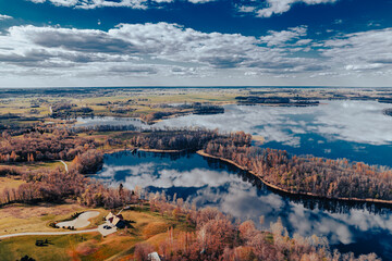 aerial view of a forest and big lake in Europe in autumn