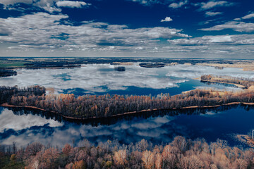 aerial view of a forest and big lake in Europe in autumn