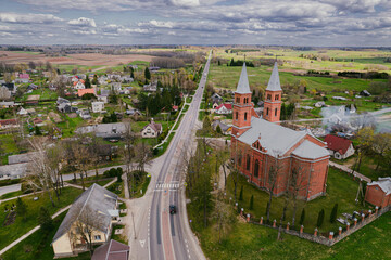 road and a church in a small European town in spring aerial photo
