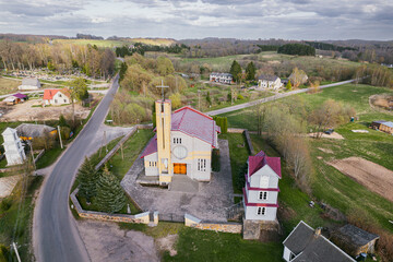 road and a church in a small European town in spring aerial photo