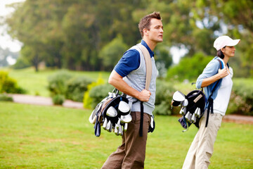 Golf, walking and couple on course with bag, space and teamwork on outdoor fitness adventure. Support, woman and man on green for sports date at club with partnership, health and wellness together