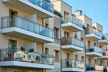 Multi story apartment building exterior. Residential building facade with balconies at summer day. Modern residential architecture in European city