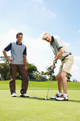 Obraz premium Game, grass and men on golf course together for teamwork, outdoor fun and fitness competition at club. Sports, senior father and son on green for partnership, bonding and support in healthy hobby.