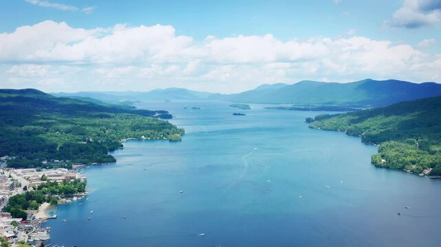 Slow pull back with a drone over Lake George and the town of Lake George, New York