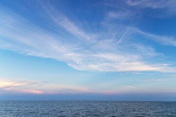 A serene ocean view with a vast sky filled with soft clouds, perfect for evoking tranquility and peace.