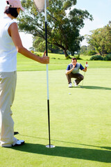 Obraz premium Club, hole and couple on golf course for coaching, outdoor fun and fitness on weekend morning together. Ball, woman and man on green grass for outdoor sports, challenge and competition with exercise.