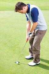 Fototapeta premium Man, putting and golf course for playing, club and outdoor fitness for competition or games. Male person, tournament and precision driver for practice match on turf, exercise and professional athlete