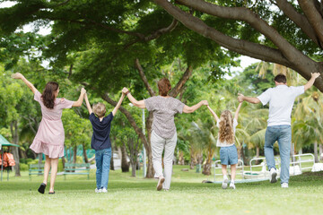 Fototapeta premium Caucasian family parent and their children picnic at the park in morning.